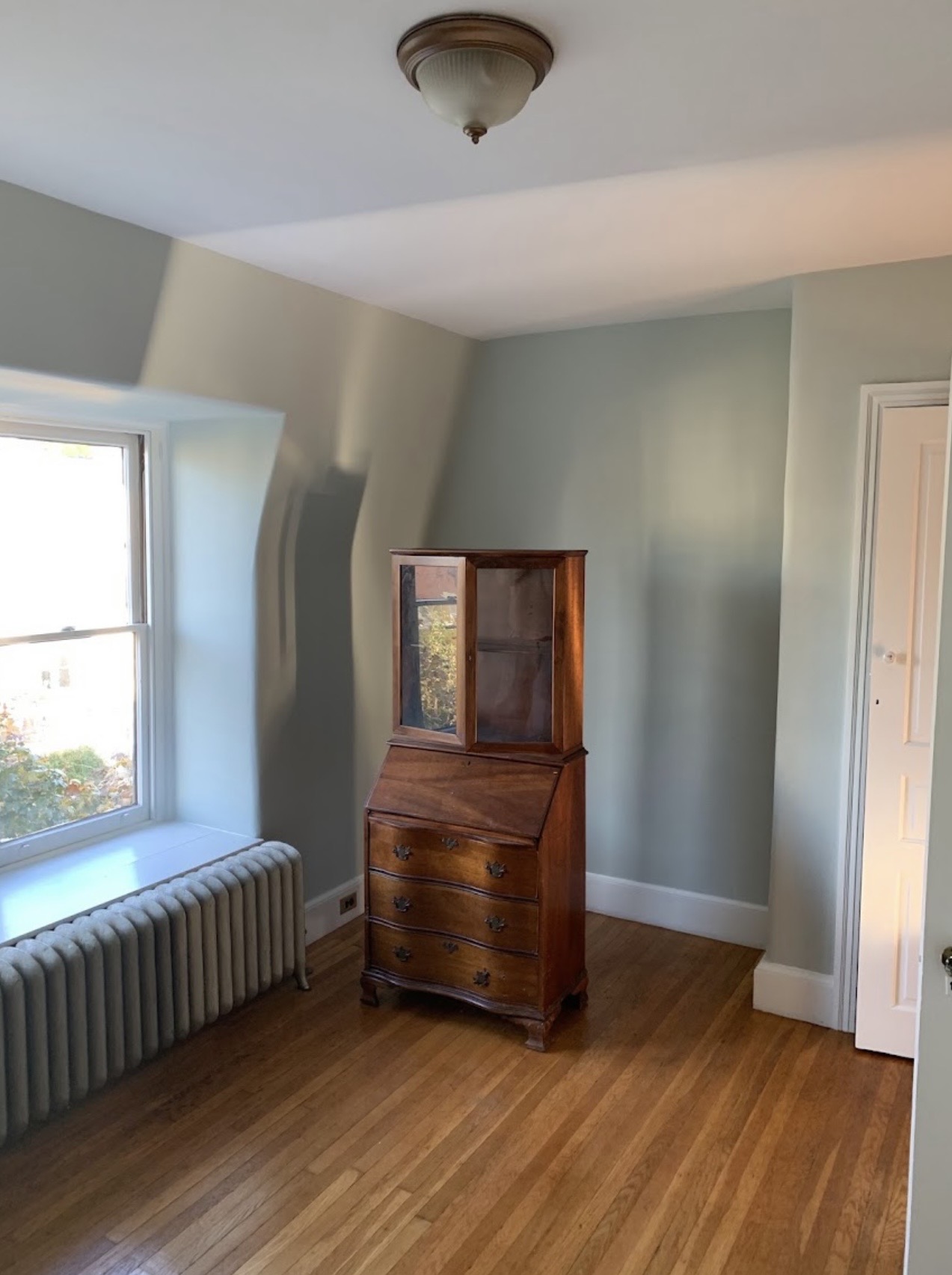 Soft green painted bedroom